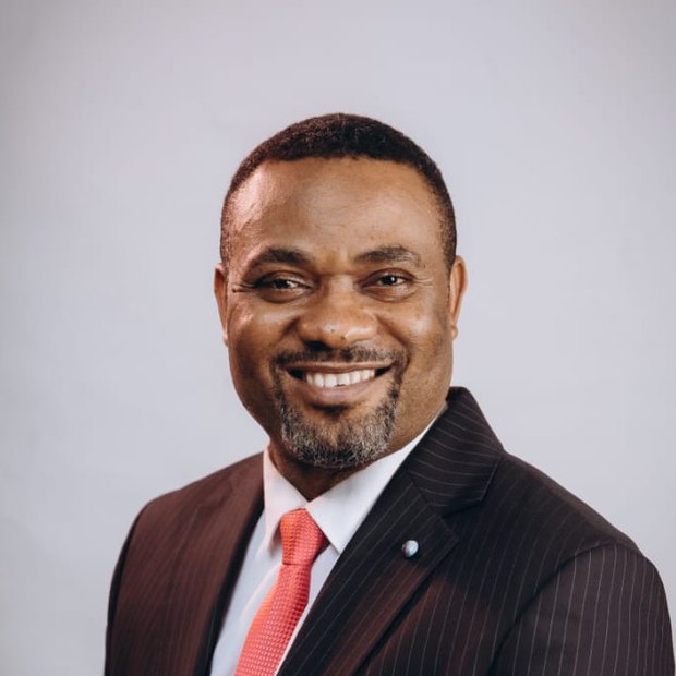 Pastor Israel Kayode-Oloje smiling in a pinstripe suit