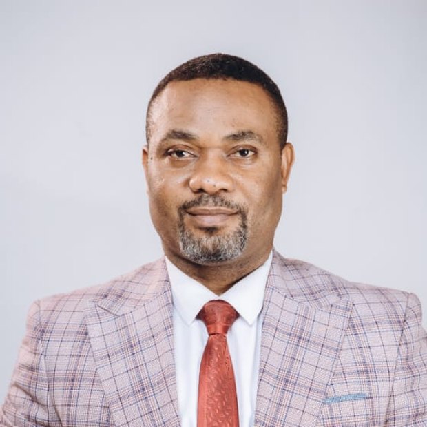 Pastor Israel Kayode-Oloje in a checked three-piece suit